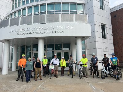 Walkers and cyclists gather outside after the end of the symposium